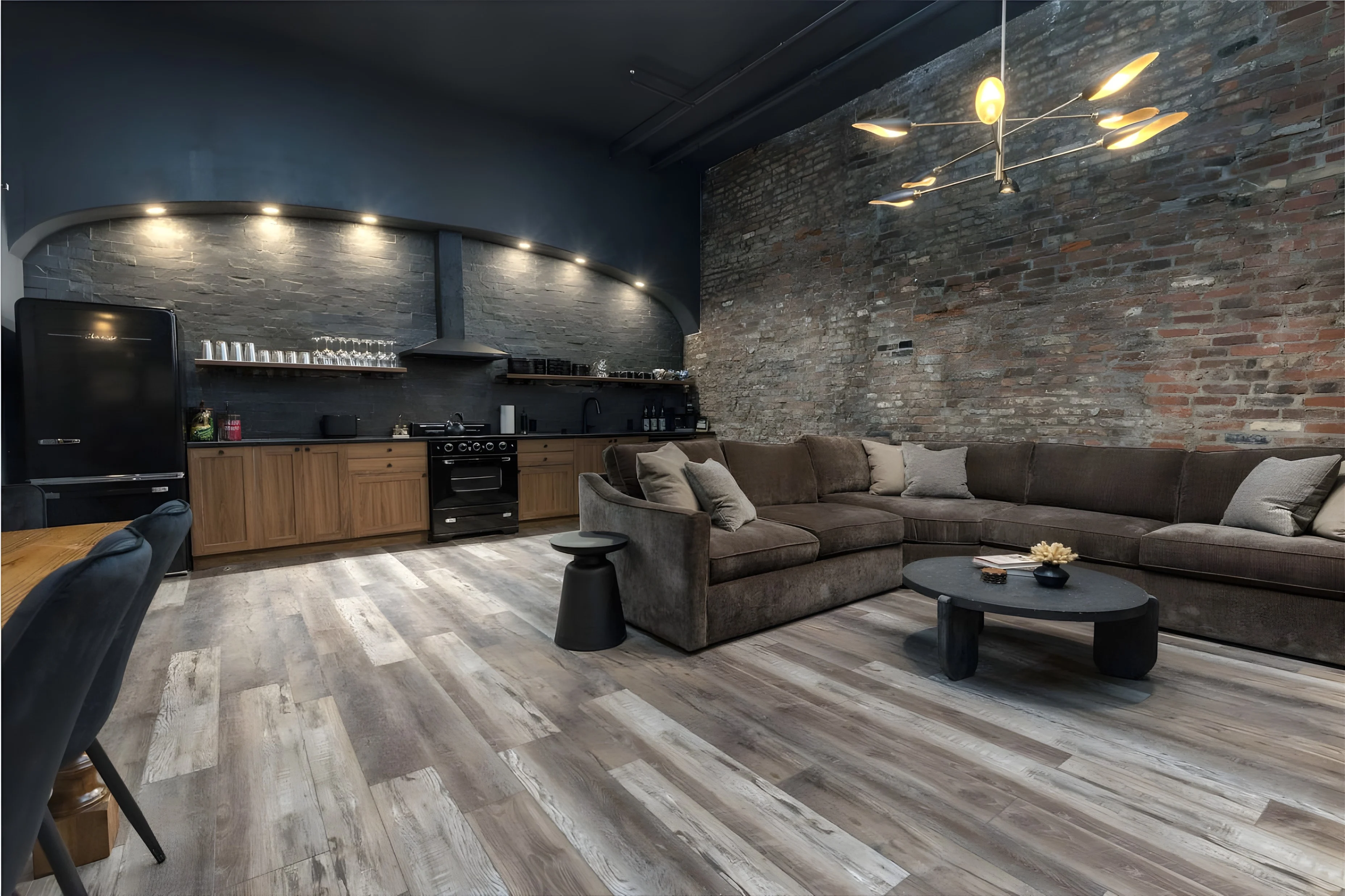 Exposed brick wall and red pine flooring in the kitchen and living space of Downtown Derby Delight on Market Street, Louisville
