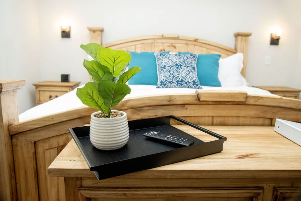 Interior of the one-bedroom Cozy St. Augustine Apartment at Pomar House, showing the king bed and kitchenette