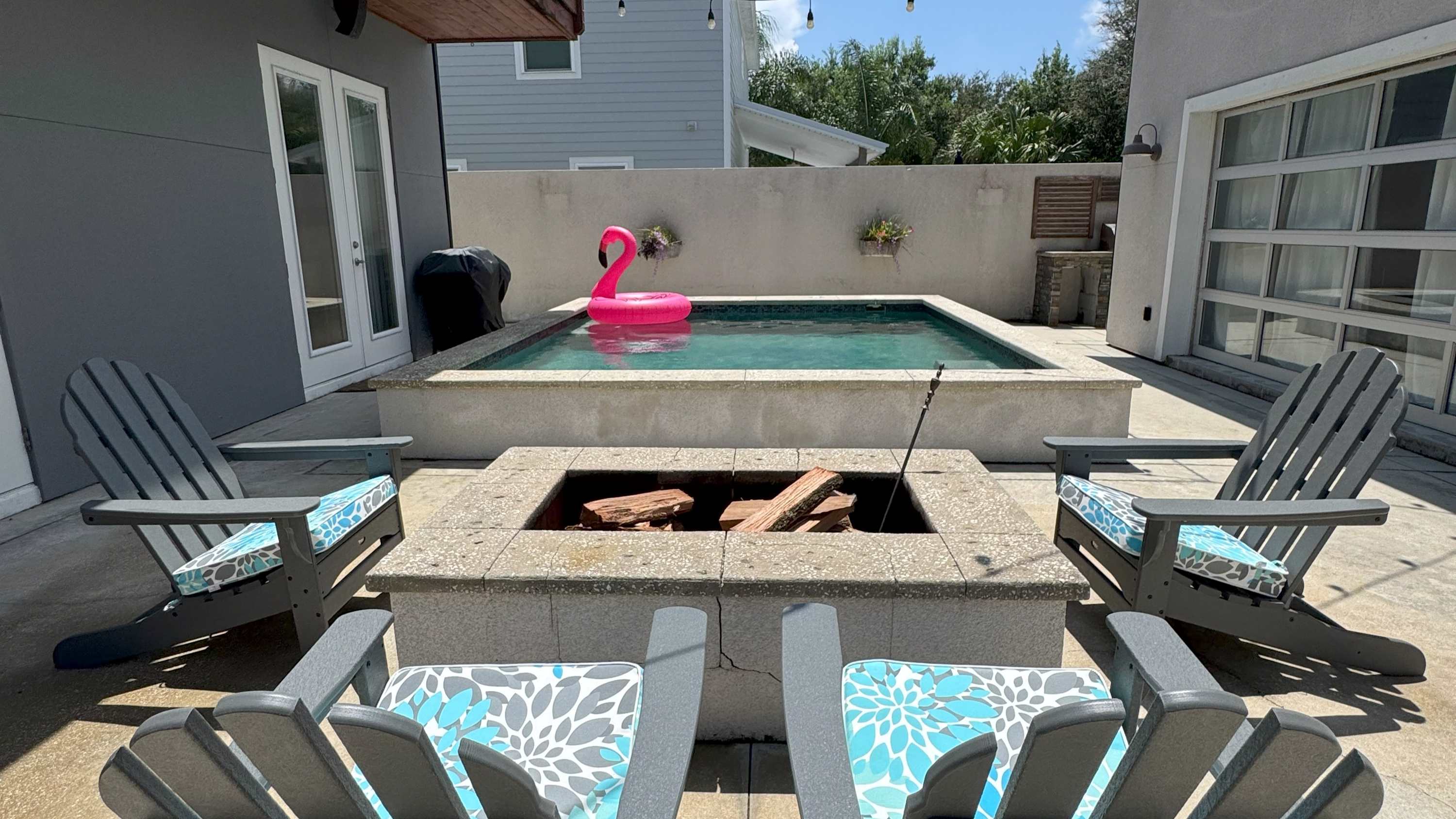 Private backyard swimming pool and fire pit at a four-bedroom St. Augustine house near Crescent Beach