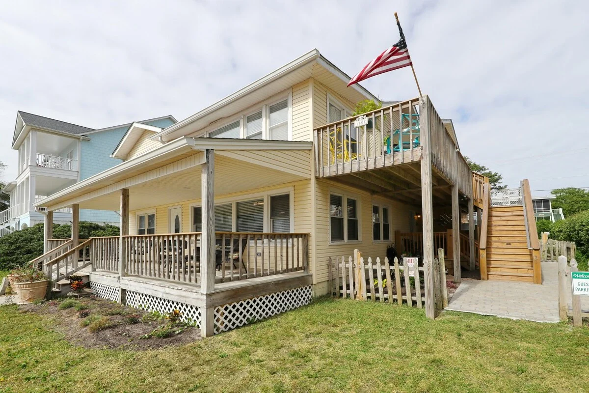 Living area and porch of Vitamin Sea JC Fun N Sun, a first-floor three-bedroom ocean view condo in North Myrtle Beach, South Carolina