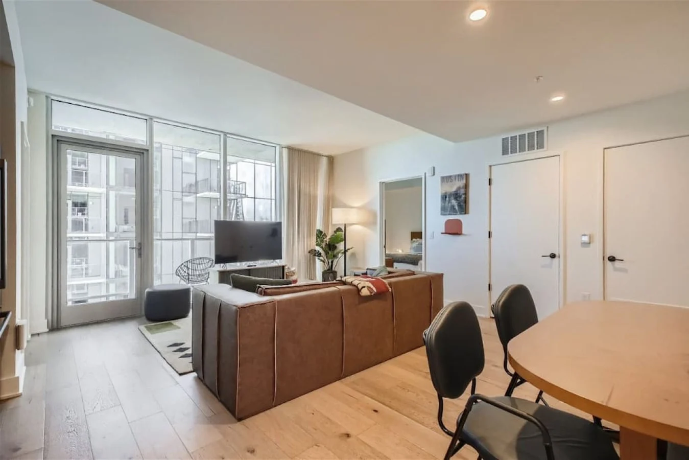 Condo living room with a sofa and large windows