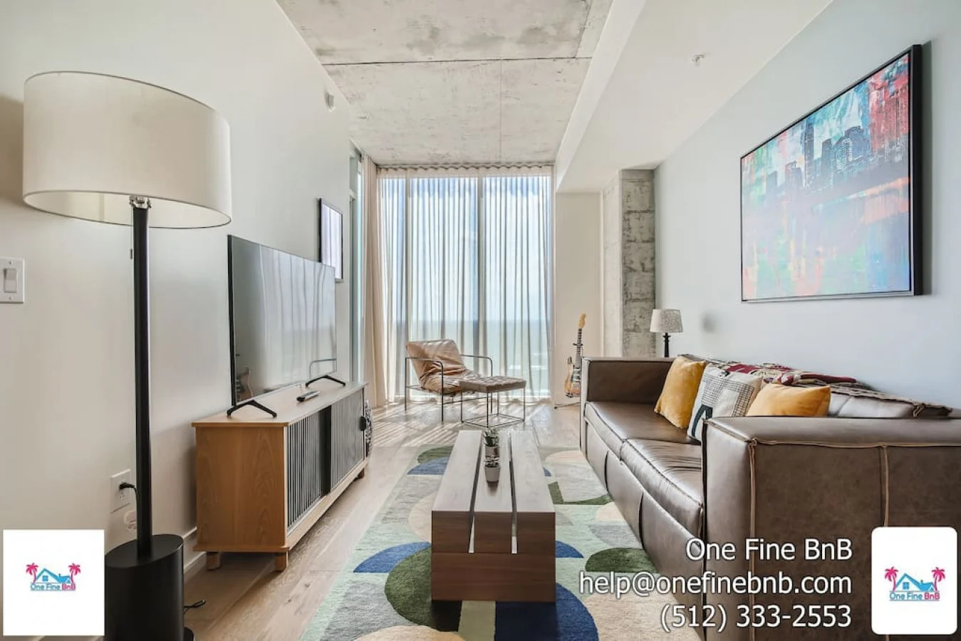 Condo living room with a sofa and wide windows