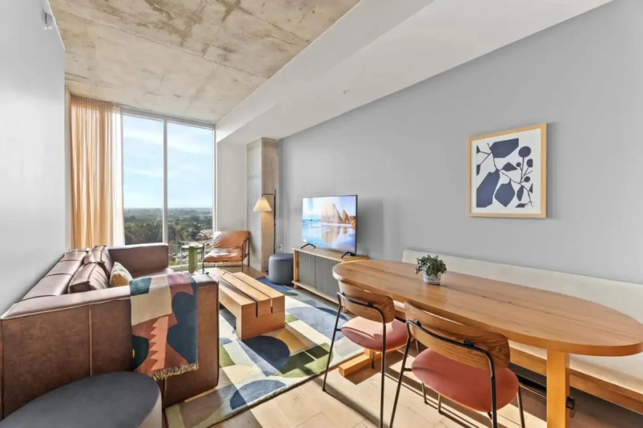 Condo living room with a sofa and large windows