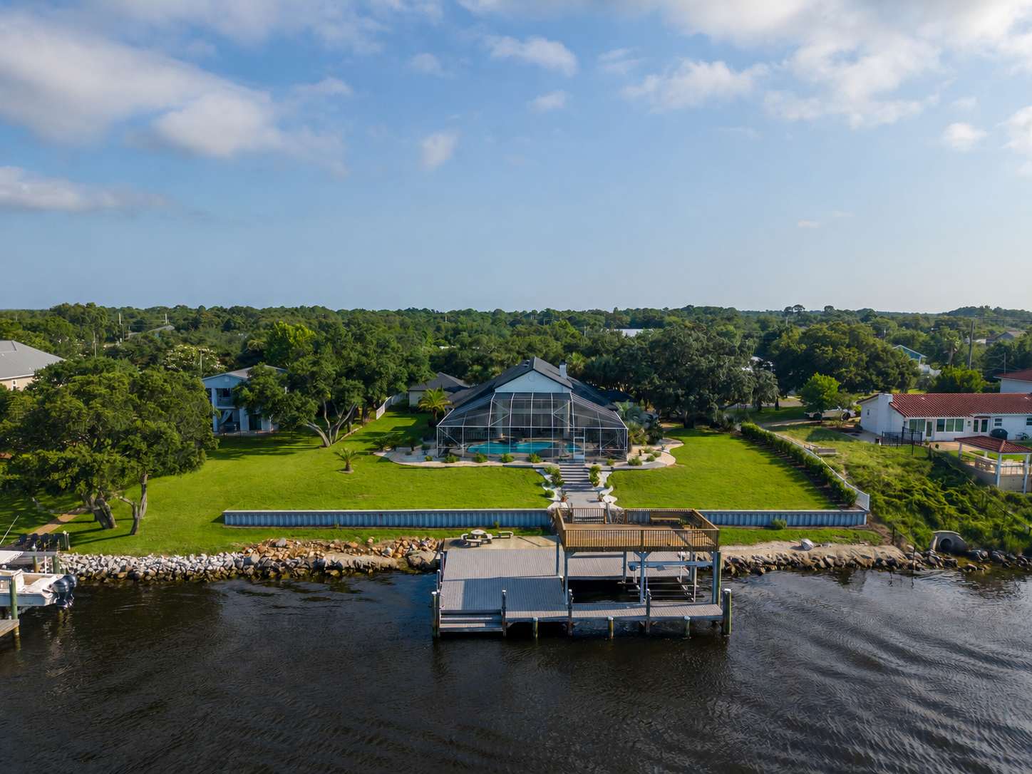 Lucky View luxury waterfront vacation rental in Pensacola, aerial view showing screened pool, private dock, and waterway