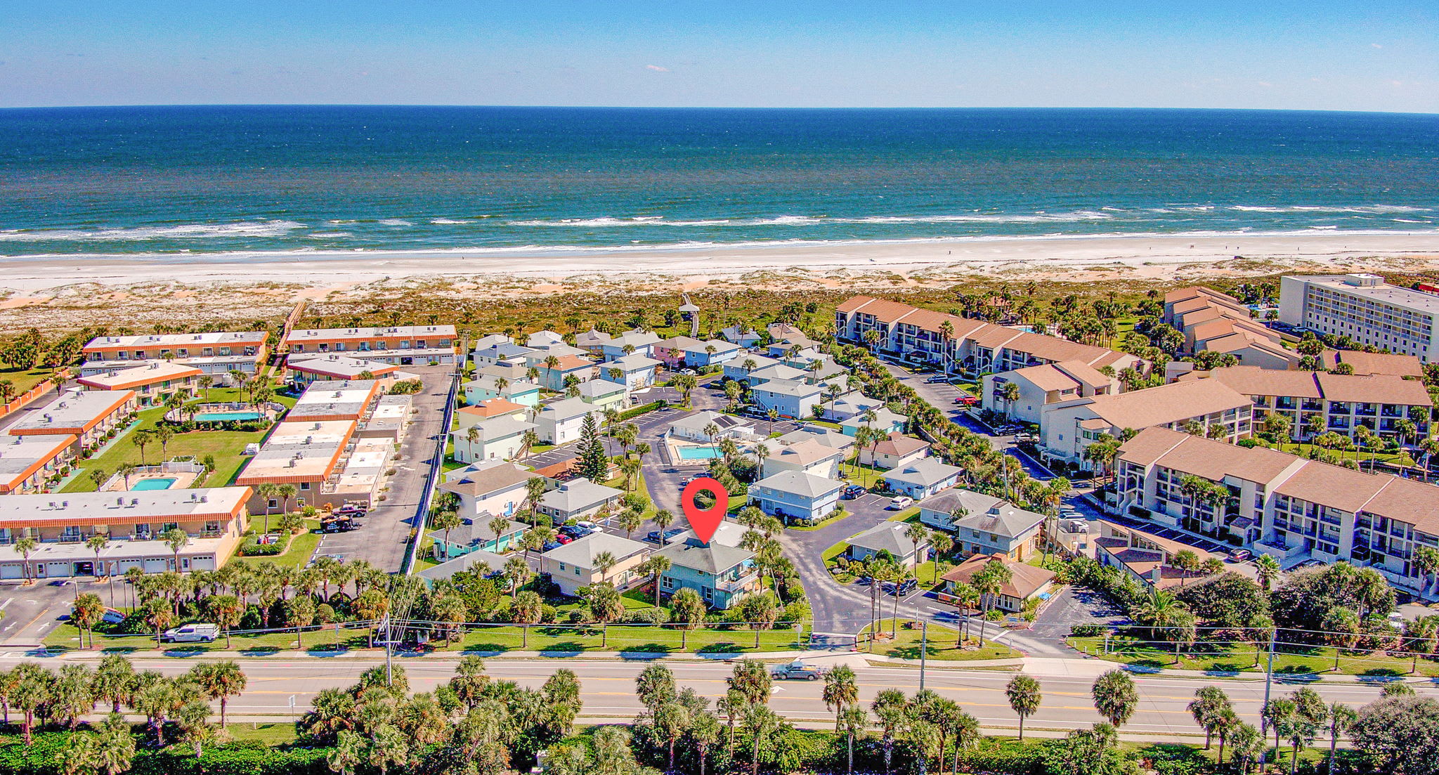 Aerial view of Beach Cottage 4BR community showing pool and beach access at St. Augustine Beach