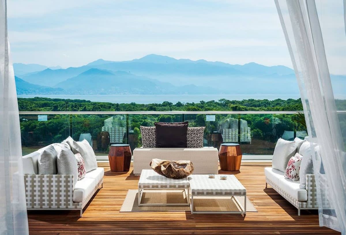 Two-floor loft interior of the Grand Luxxe 3BR Loft Residence in Bucerías, showing the living area and breakfast bar