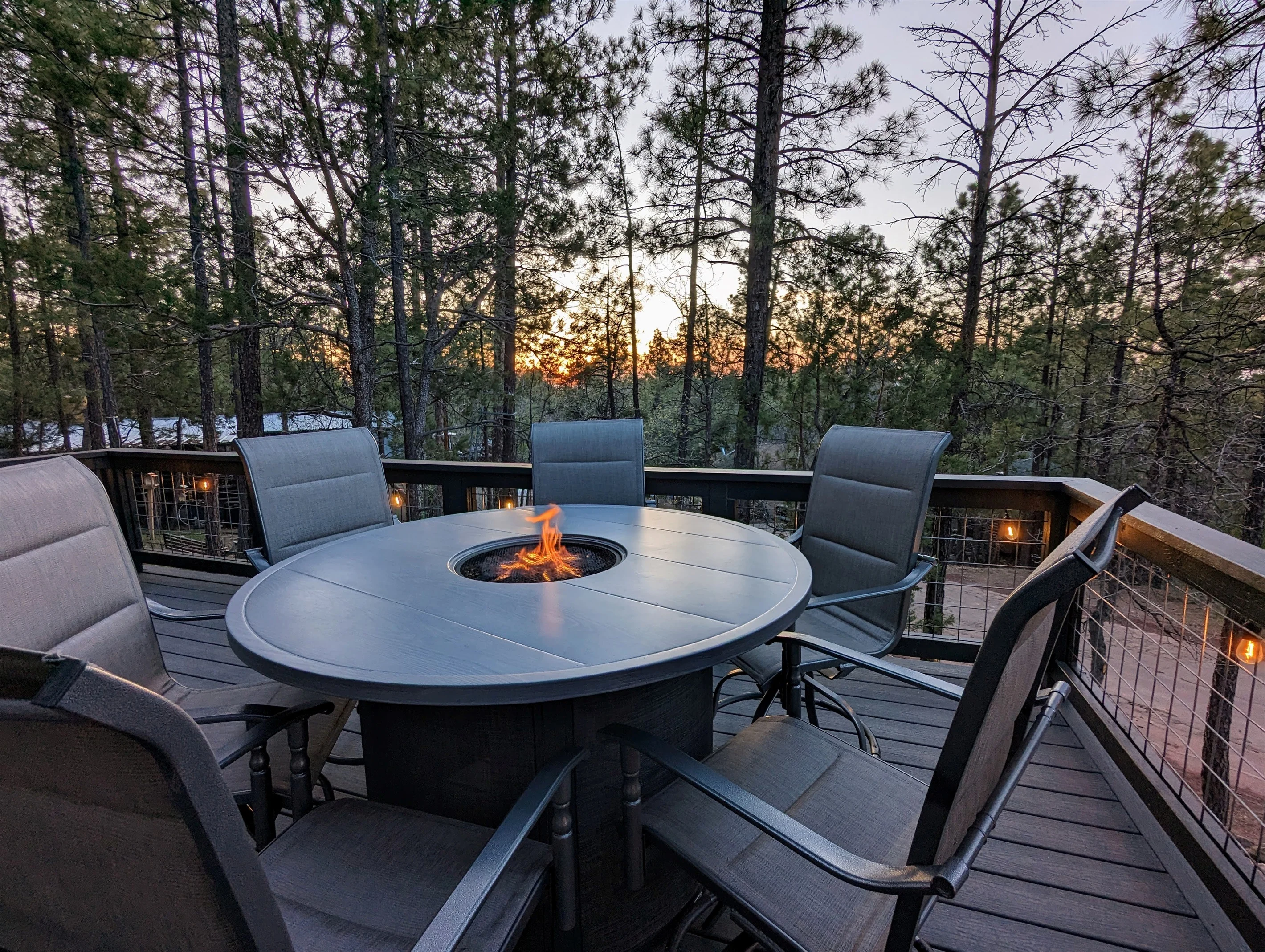 Fire pit table on a deck at sunset in the Pinetop pines