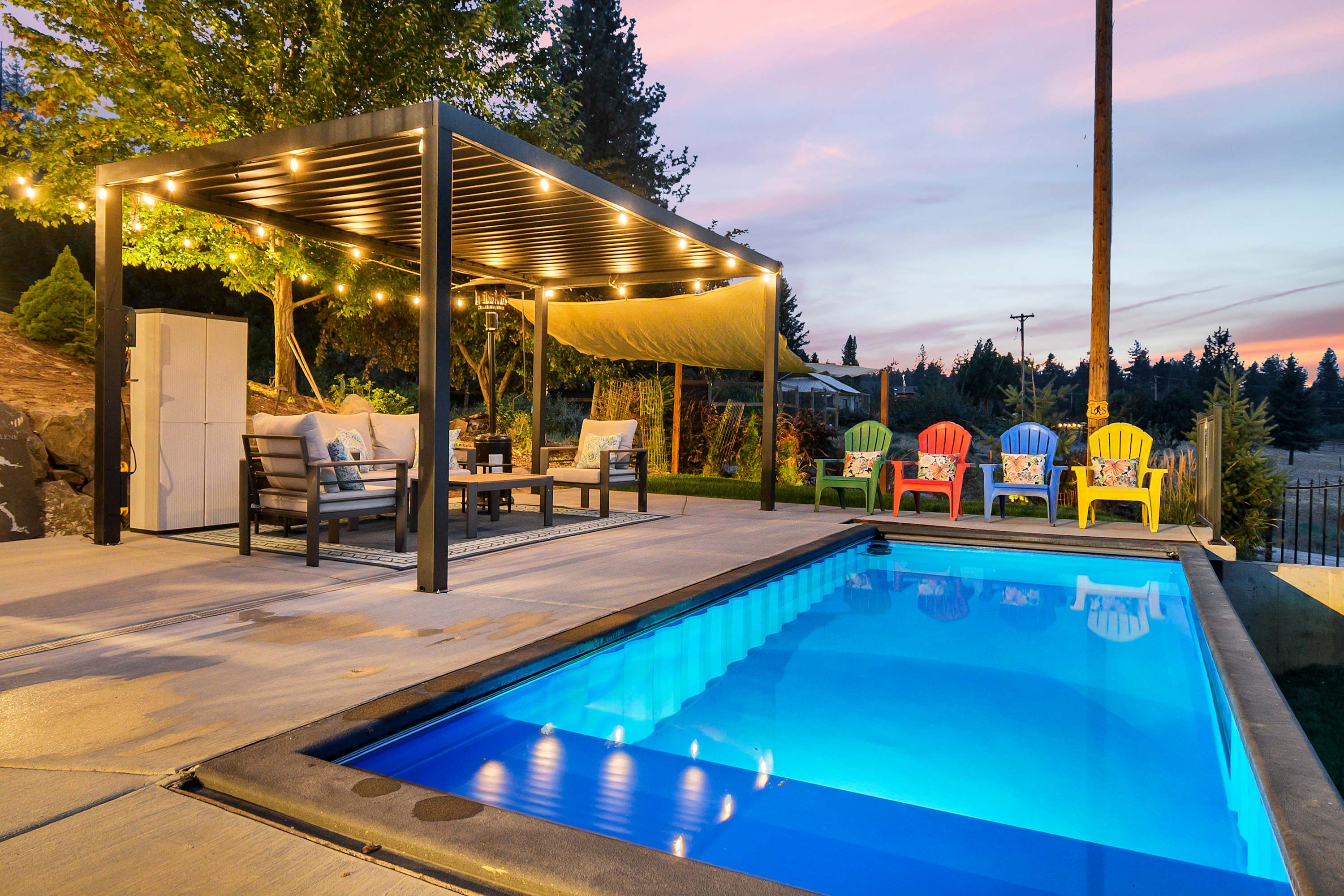 Heated pool and pergola at a North Idaho vacation rental at sunset
