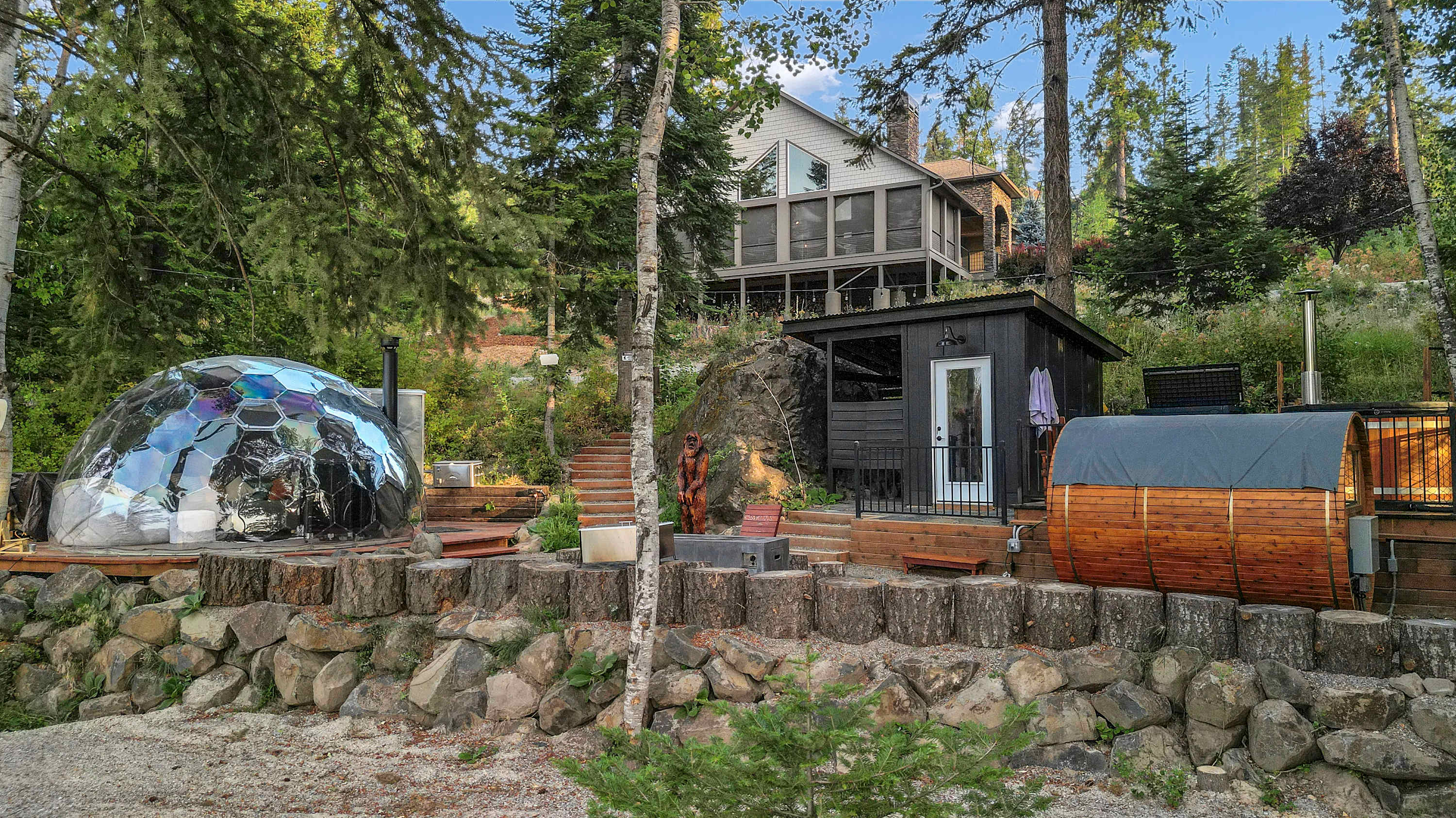 Sasquatch Lodge exterior with stargazing dome and barrel sauna in North Idaho