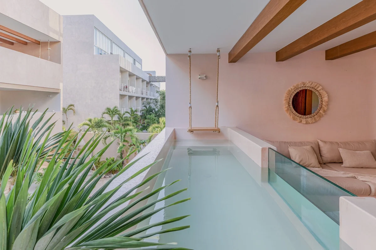 Covered private terrace and plunge pool opening off the lounge of a two-bedroom apartment in Tulum